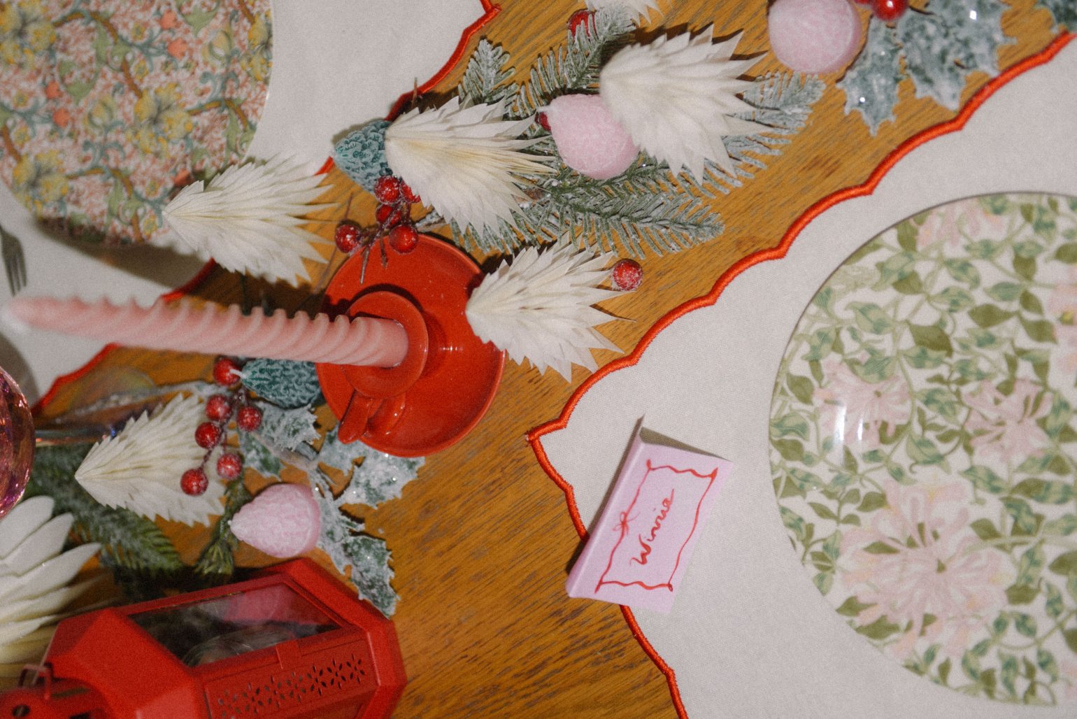 Floral plate and pink candle on dining table
